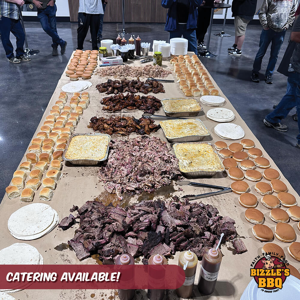 a large catering table covered in smoked meats, breads, and sauces